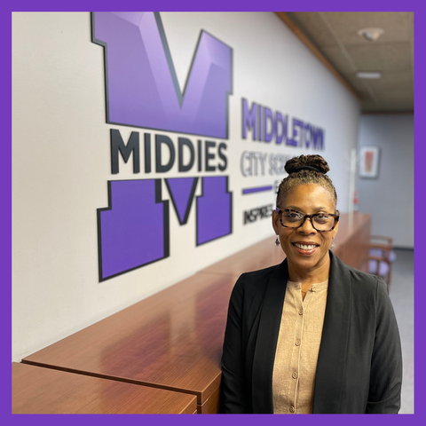 Picture of woman smiling with Middletown City School District logo in the background